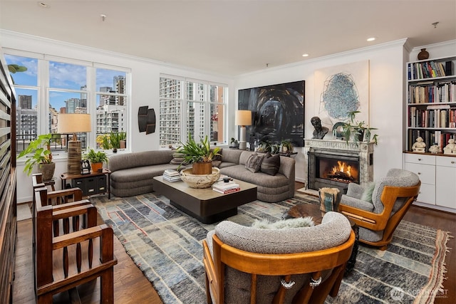 1009 Western Ave Unit 1203, Seattle, WA 98104 - sitting room with a lit fireplace, wood finished floors, ornamental molding, and a city view
