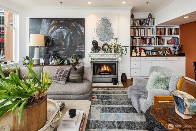 1009 Western Ave Unit 1203, Seattle, WA 98104 - sitting room with wood finished floors, a fireplace with flush hearth, ornamental molding, and recessed lighting