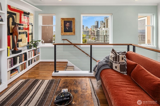 1009 Western Ave Unit 1203, Seattle, WA 98104 - sitting room with wood finished floors, ornamental molding, a skyline view, an upstairs landing, and baseboards