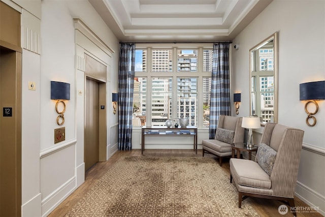 1009 Western Ave Unit 1203, Seattle, WA 98104 - sitting room featuring elevator, wood finished floors, and a raised ceiling
