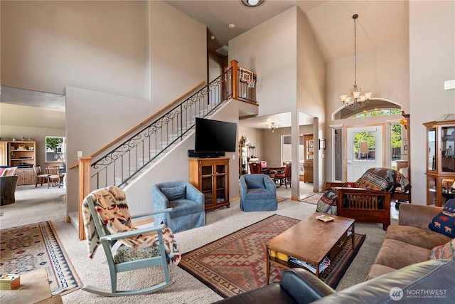 2541 Fancher Heights Blvd, East Wenatchee, WA 98802 - living area with a high ceiling, carpet flooring, a chandelier, and stairs