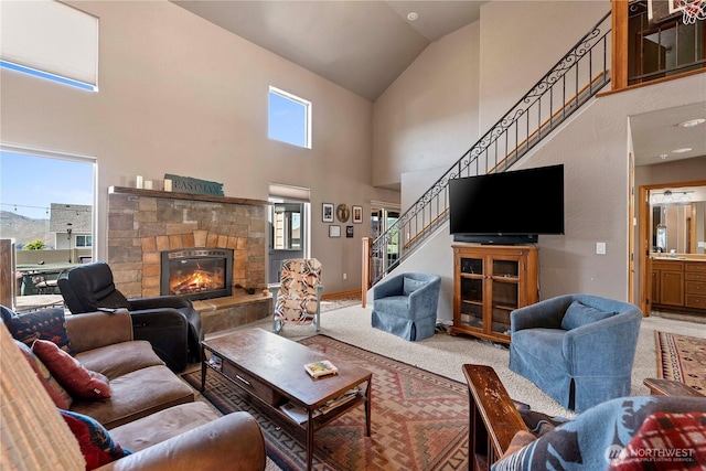 2541 Fancher Heights Blvd, East Wenatchee, WA 98802 - carpeted living room featuring stairs, high vaulted ceiling, and a stone fireplace