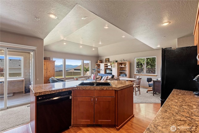 2541 Fancher Heights Blvd, East Wenatchee, WA 98802 - kitchen with black appliances, a textured ceiling, tile countertops, light wood-type flooring, and open floor plan