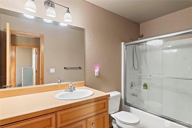 2541 Fancher Heights Blvd, East Wenatchee, WA 98802 - full bathroom featuring a textured wall, vanity, bath / shower combo with glass door, and toilet