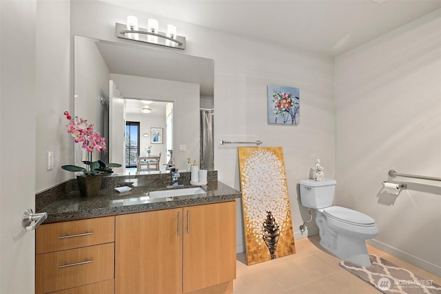 bathroom featuring toilet, tile patterned floors, and vanity