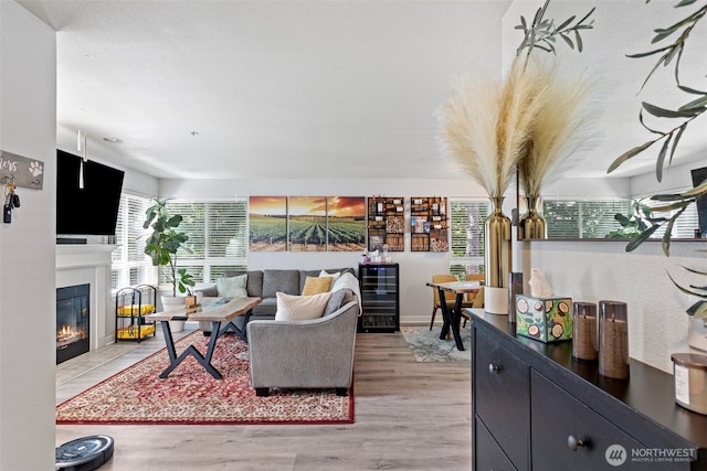 3908 243rd Pl SE Unit Q-203, Bothell, WA 98021 - living room featuring wood finished floors and a fireplace with flush hearth