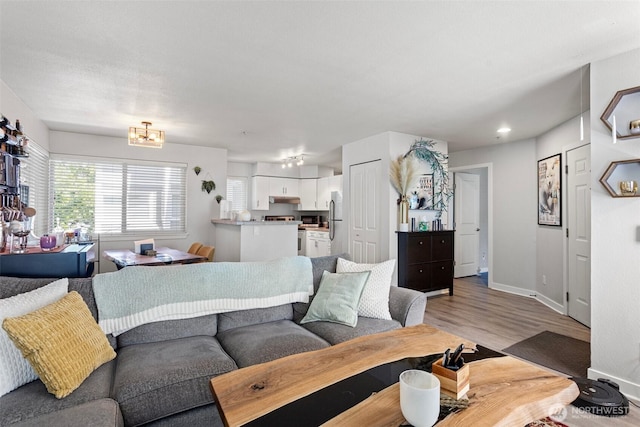3908 243rd Pl SE Unit Q-203, Bothell, WA 98021 - living room featuring light wood-style flooring and baseboards