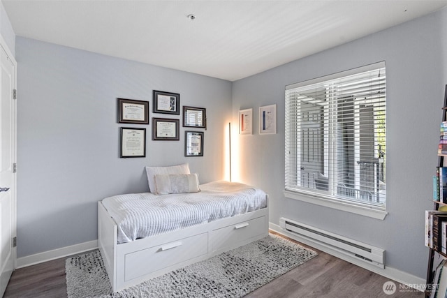 3908 243rd Pl SE Unit Q-203, Bothell, WA 98021 - bedroom with baseboard heating, wood finished floors, and baseboards