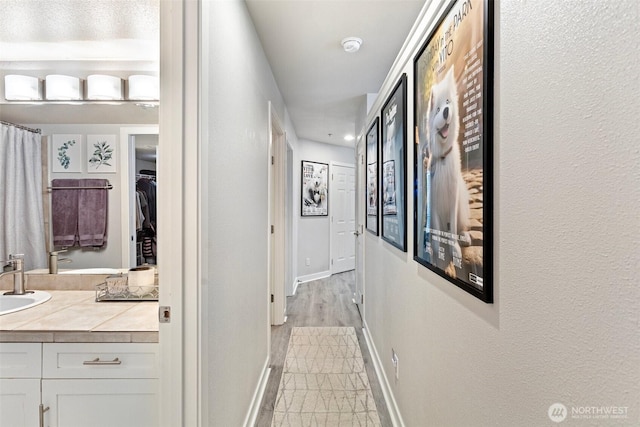 3908 243rd Pl SE Unit Q-203, Bothell, WA 98021 - corridor with baseboards, a sink, and recessed lighting