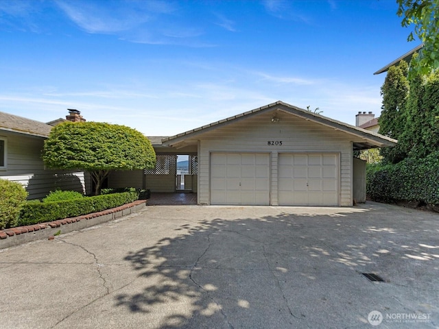 view of front of property with a detached garage, an outdoor structure, and a chimney