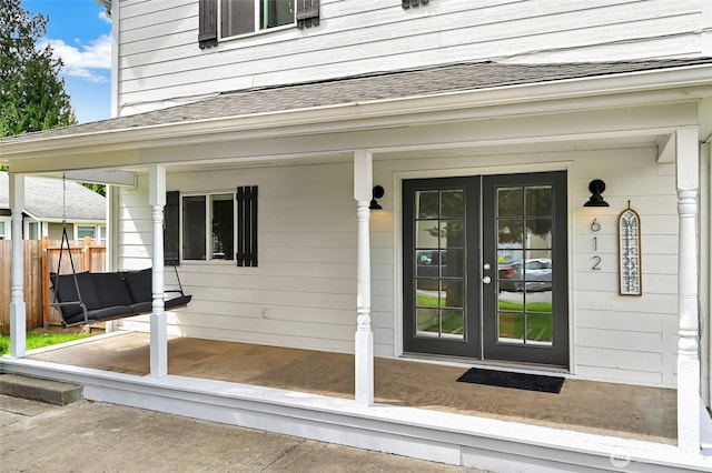 612 Hunt Ave, Sumner, WA 98390 - doorway to property featuring a shingled roof, fence, french doors, and a porch