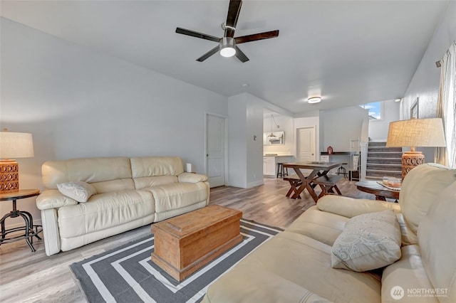 612 Hunt Ave, Sumner, WA 98390 - living area featuring light wood-style flooring, ceiling fan, and stairway
