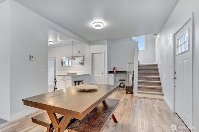 612 Hunt Ave, Sumner, WA 98390 - dining space featuring stairs, baseboards, and light wood-style flooring