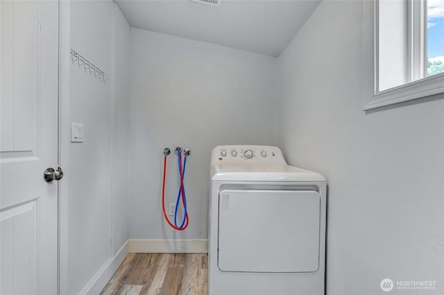 612 Hunt Ave, Sumner, WA 98390 - laundry room with washer / dryer, wood finished floors, and baseboards