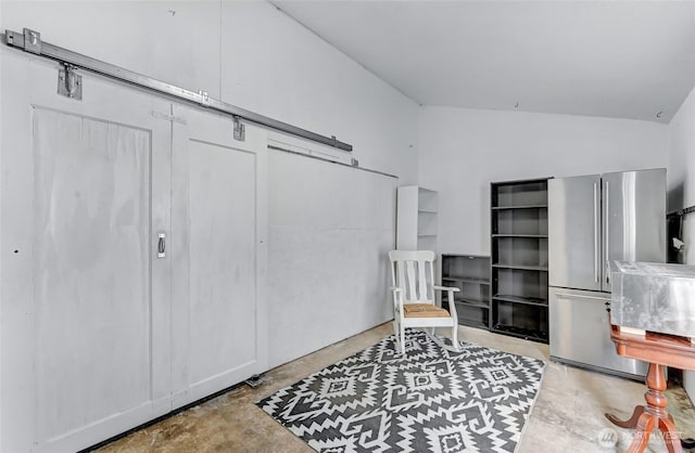 612 Hunt Ave, Sumner, WA 98390 - sitting room featuring concrete flooring, a barn door, and vaulted ceiling