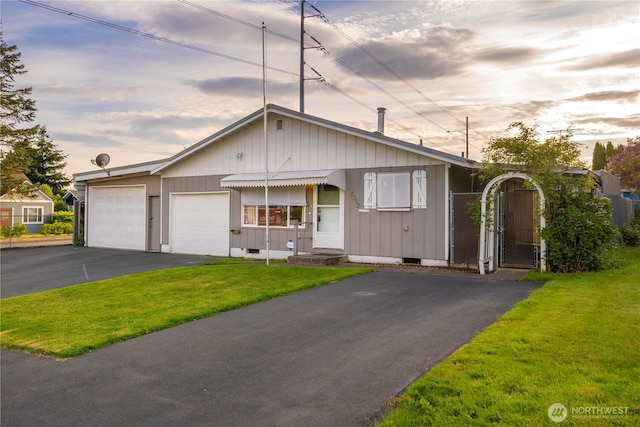 7052 S I St, Tacoma, WA 98408 - view of front of house with driveway, a garage, a front yard, crawl space, and a gate