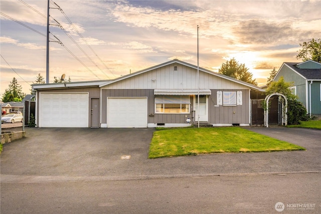 7052 S I St, Tacoma, WA 98408 - view of front facade with driveway, a lawn, and a garage