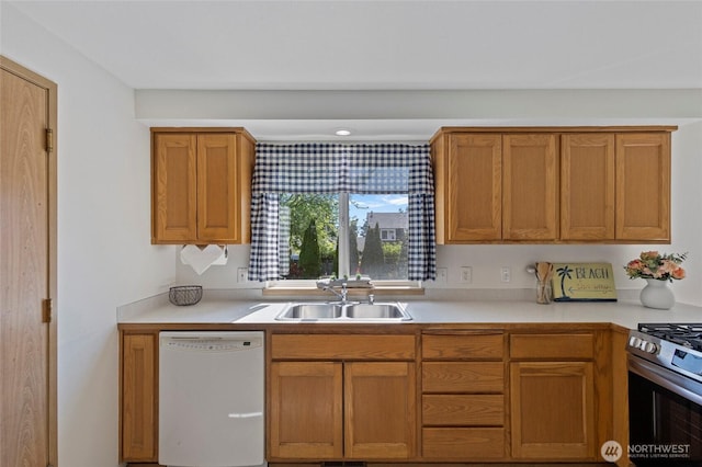 1274 Admirals Dr, Coupeville, WA 98239 - kitchen featuring white dishwasher, a sink, light countertops, gas stove, and brown cabinets