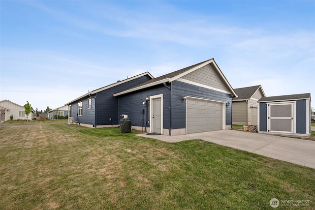 view of home's exterior with a storage unit, driveway, a garage, a lawn, and an outbuilding