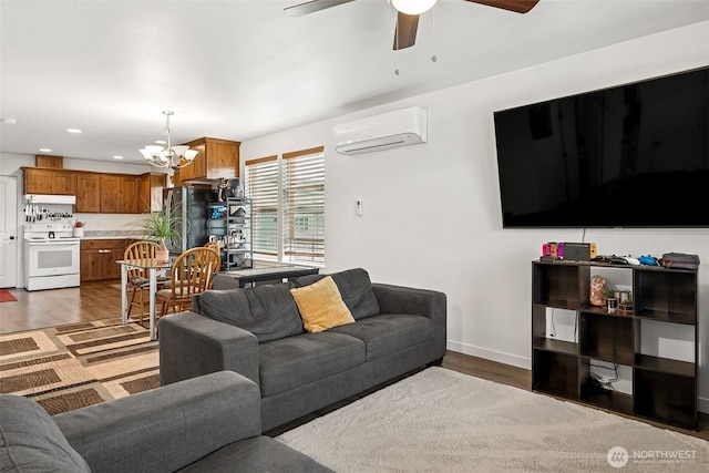 living area featuring an AC wall unit, wood finished floors, a chandelier, ceiling fan, and recessed lighting