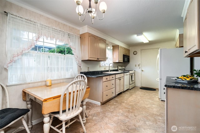2129 H Ave, Anacortes, WA 98221 - kitchen featuring a sink, white appliances, dark countertops, stone finish flooring, and a chandelier