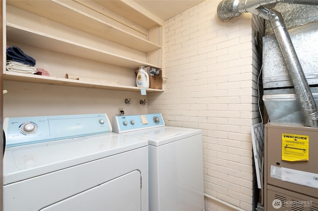 2129 H Ave, Anacortes, WA 98221 - laundry area featuring washer and clothes dryer and brick wall