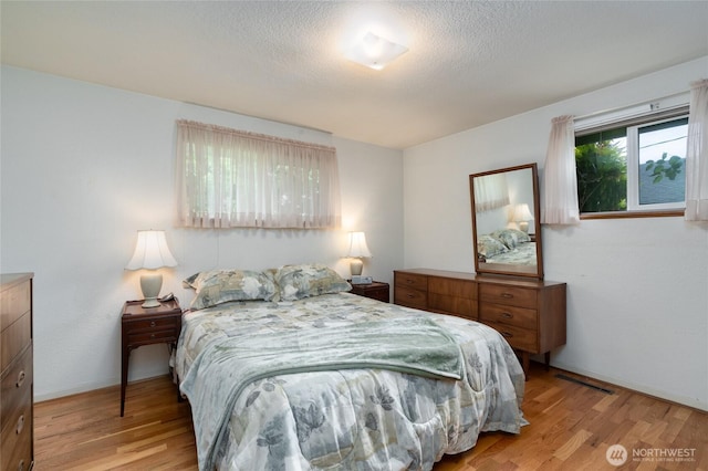 2129 H Ave, Anacortes, WA 98221 - bedroom with wood finished floors, a textured ceiling, and baseboards