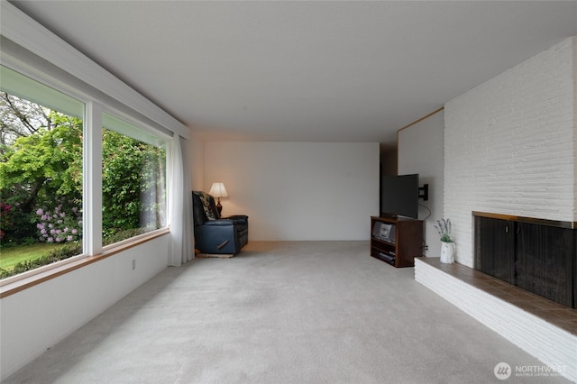 2129 H Ave, Anacortes, WA 98221 - unfurnished living room with carpet flooring and a brick fireplace