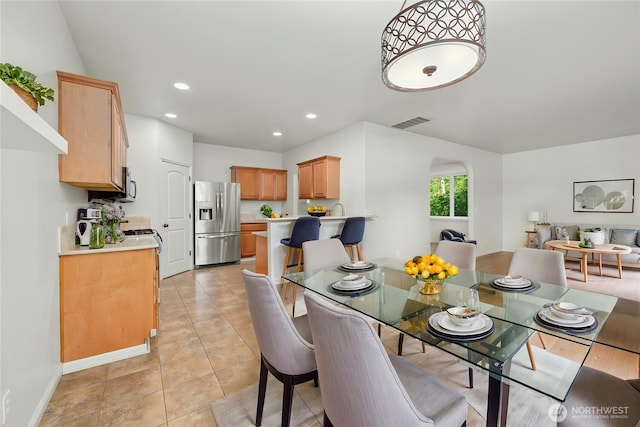 18910 SE 41st Dr, Vancouver, WA 98683 - dining area featuring arched walkways, recessed lighting, light tile patterned floors, and baseboards