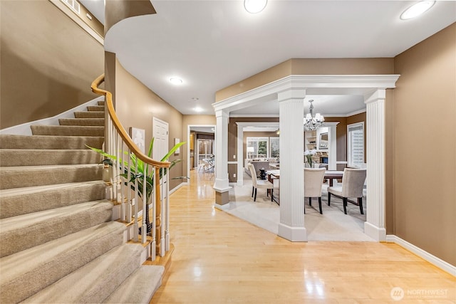 908 274th Way SE, Sammamish, WA 98075 - entrance foyer featuring decorative columns, wood finished floors, stairs, baseboards, and a chandelier