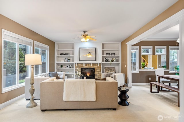 908 274th Way SE, Sammamish, WA 98075 - living room featuring baseboards, a fireplace, light colored carpet, a ceiling fan, and built in shelves