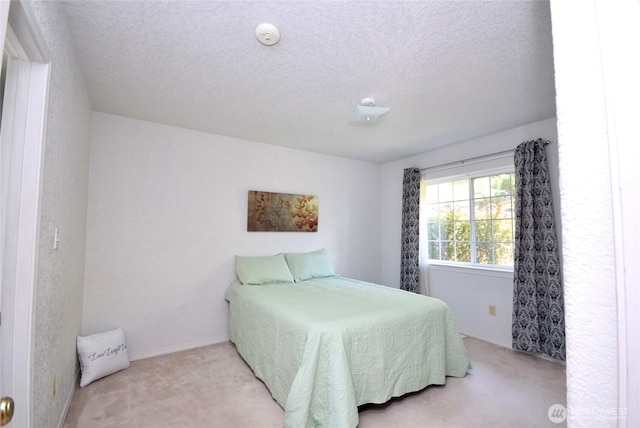 bedroom with carpet flooring and a textured ceiling