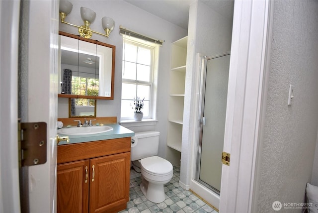 full bathroom with a stall shower, toilet, vanity, and tile patterned floors