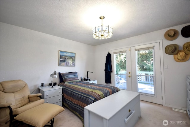 bedroom featuring french doors, access to exterior, light carpet, a chandelier, and a textured ceiling