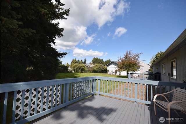 wooden deck featuring a yard