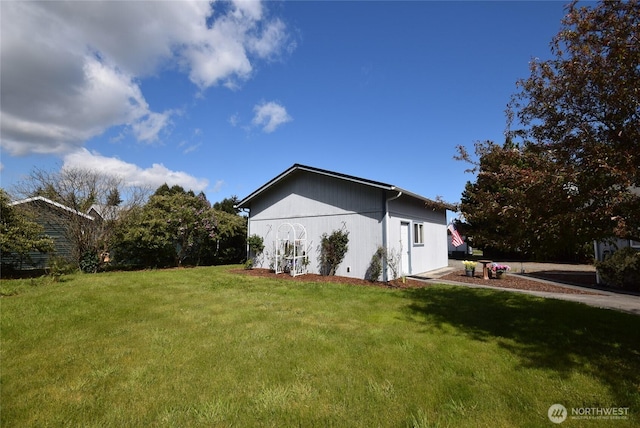view of side of property featuring a yard