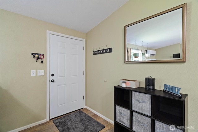 foyer with wood finished floors and baseboards