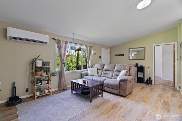 living area with a wall unit AC, light wood-type flooring, baseboards, and vaulted ceiling