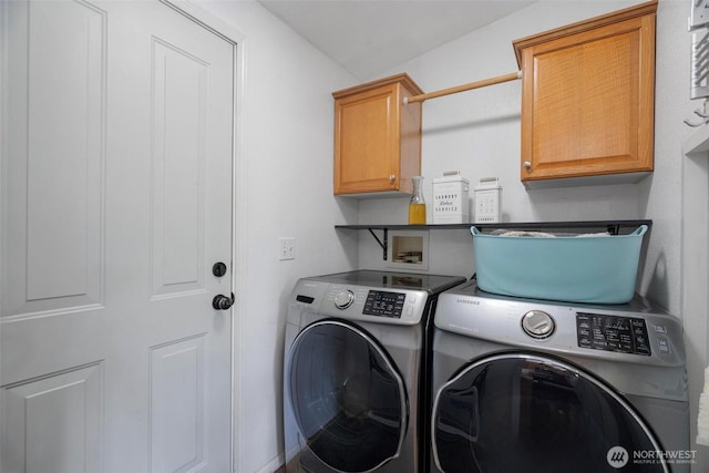 laundry area featuring independent washer and dryer and cabinet space