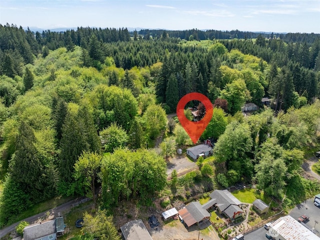 aerial view of property's location with a heavily wooded area