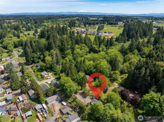 view of property location featuring a heavily wooded area