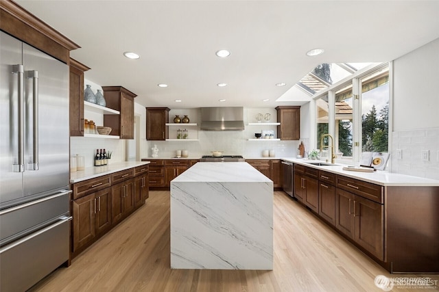 9416 NE 25th St, Clyde Hill, WA 98004 - kitchen featuring open shelves, appliances with stainless steel finishes, wall chimney range hood, backsplash, and a sink