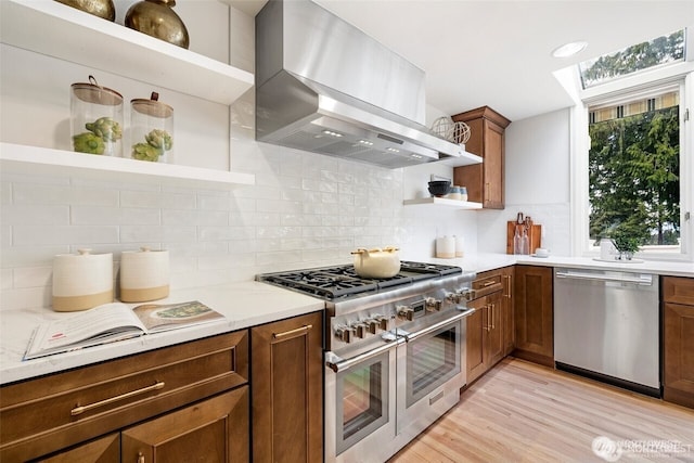 9416 NE 25th St, Clyde Hill, WA 98004 - kitchen featuring open shelves, stainless steel appliances, wall chimney exhaust hood, and light wood-type flooring