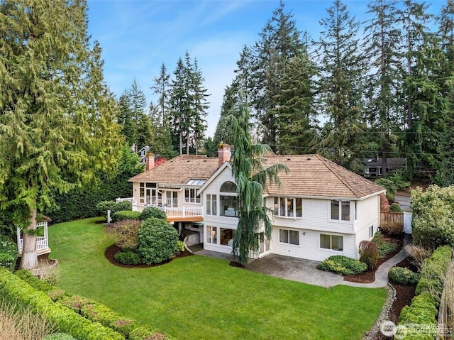 9416 NE 25th St, Clyde Hill, WA 98004 - back of house with a patio area, a chimney, a lawn, and view of scattered trees