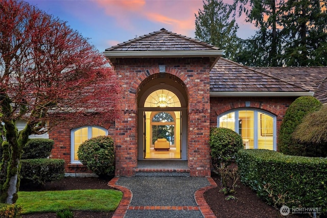 9416 NE 25th St, Clyde Hill, WA 98004 - exterior entry at dusk featuring brick siding