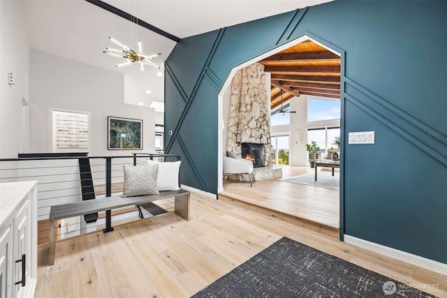 4950 N Lexington St, Tacoma, WA 98407 - entrance foyer with light wood-style flooring, a fireplace, ceiling fan, high vaulted ceiling, and a chandelier