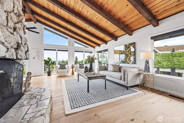 4950 N Lexington St, Tacoma, WA 98407 - living area featuring healthy amount of natural light, wood ceiling with exposed beams, hardwood / wood-style floors, a fireplace, and high vaulted ceiling