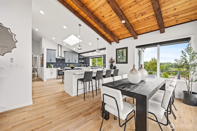 4950 N Lexington St, Tacoma, WA 98407 - dining area with light wood-type flooring, recessed lighting, wood ceiling with exposed beams, a skylight, and high vaulted ceiling