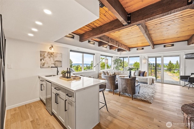 4950 N Lexington St, Tacoma, WA 98407 - kitchen featuring open floor plan, wood ceiling with exposed beams, wine cooler, a breakfast bar, and plenty of natural light