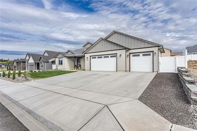 819 N Newport Loop, East Wenatchee, WA 98802 - view of front facade with board and batten siding, a garage, concrete driveway, and a residential view